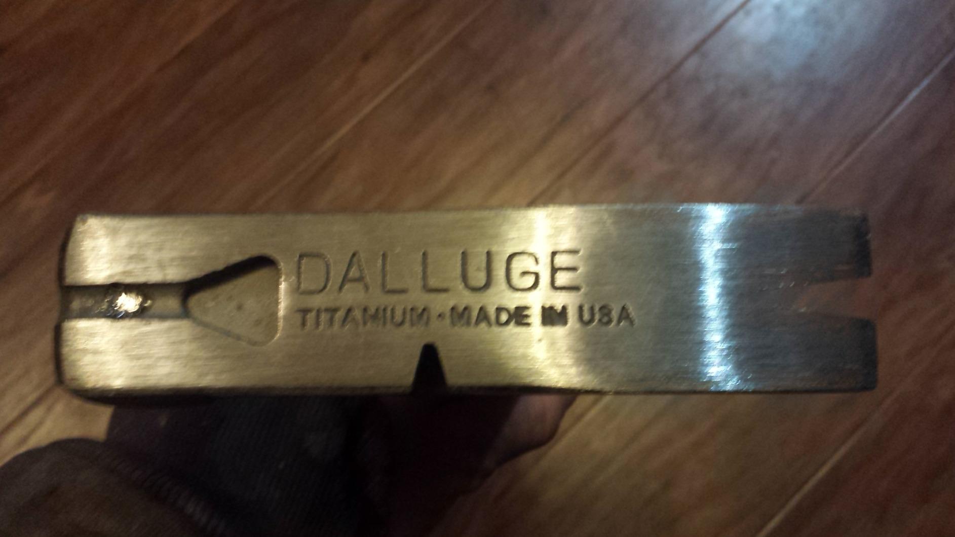 Side of a Dalluge titanium hammer head stamped DALLUGE TITANIUM MADE IN USA, with the nail-pulling slot visible